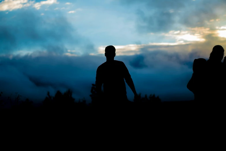 silhouettes of a man and woman against the sky