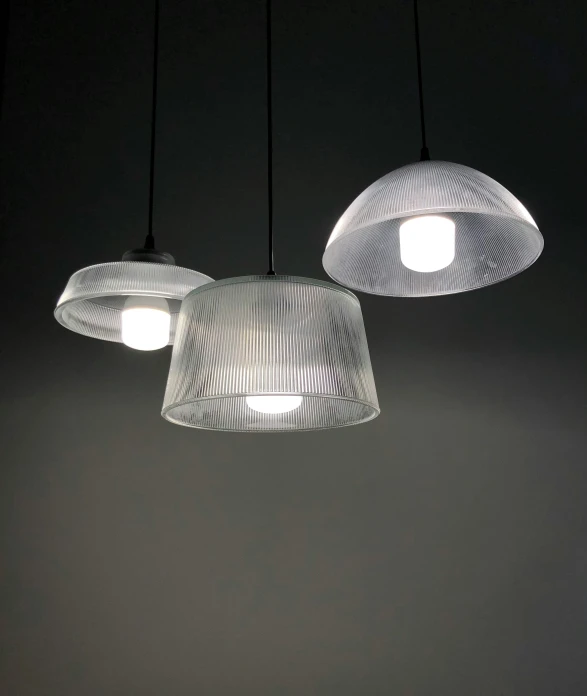 three pendant lamps suspended above the floor in a dimly lit room