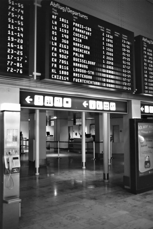 a sign and two people standing at the airport