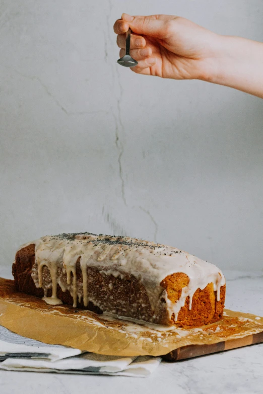 a person reaching for a piece of cake on a  board