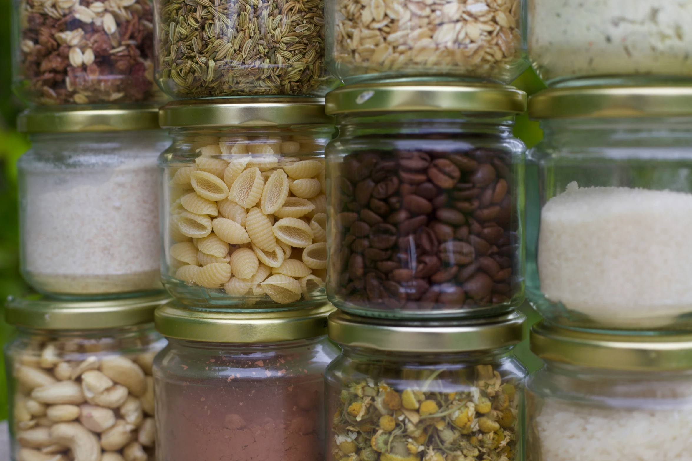 various types of spices and nuts in a glass container