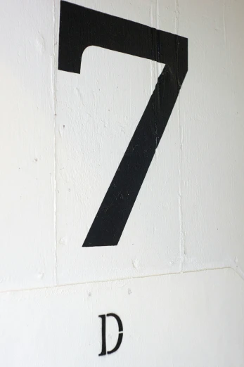 the street sign shows the number seven and has a black z