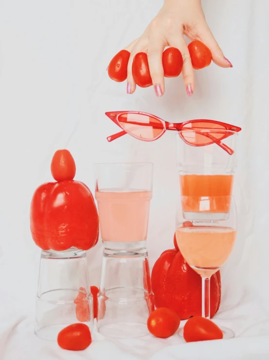 an image of glasses that are by tomatoes