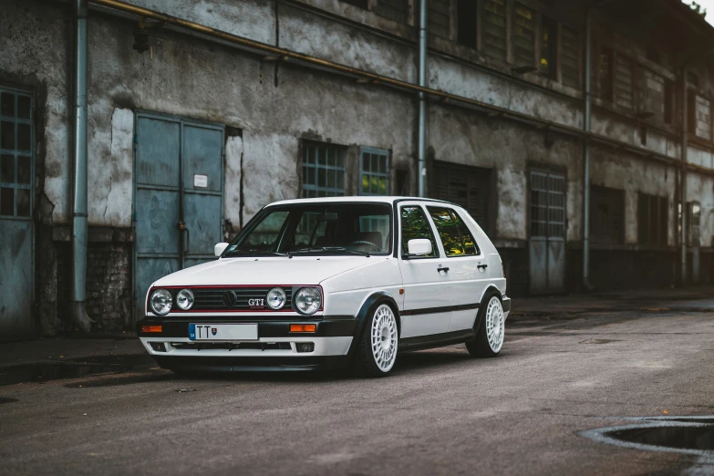 an old white car parked on the street