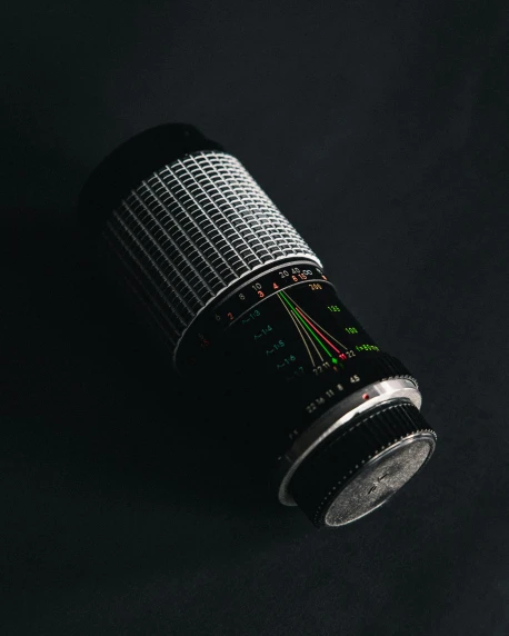 an old - fashioned camera lens is set on a black background