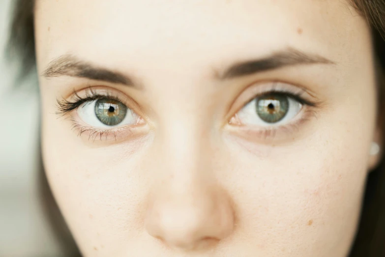 a girl with blue eyes is looking at the camera
