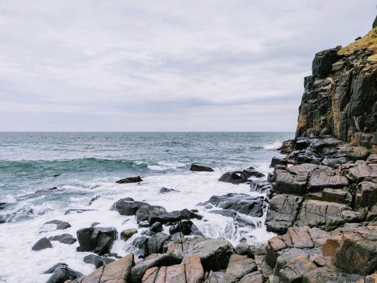 the rocky shoreline is seen from the rocks