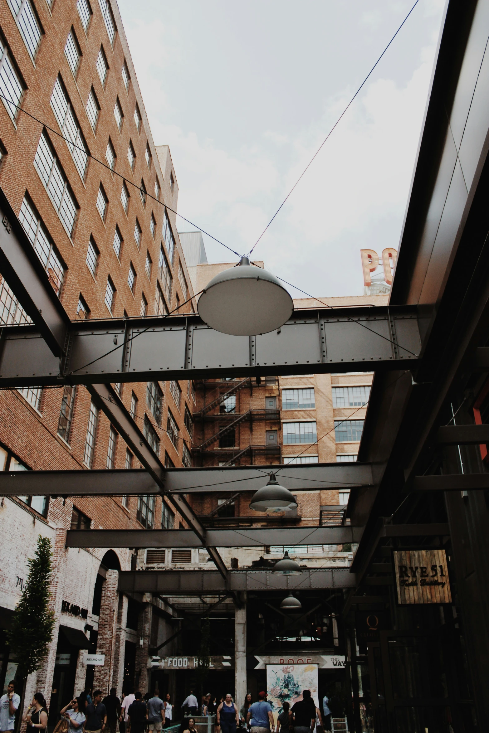 people sitting under a building under an overhead structure