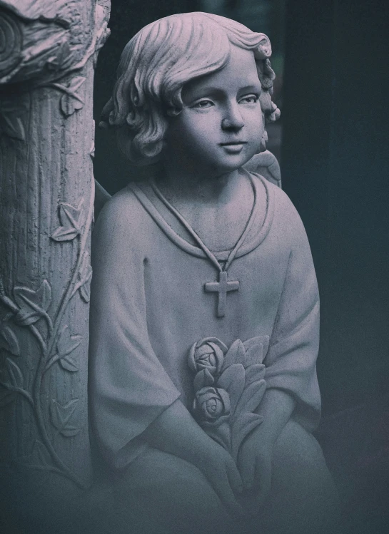 a statue of a child wearing a necklace