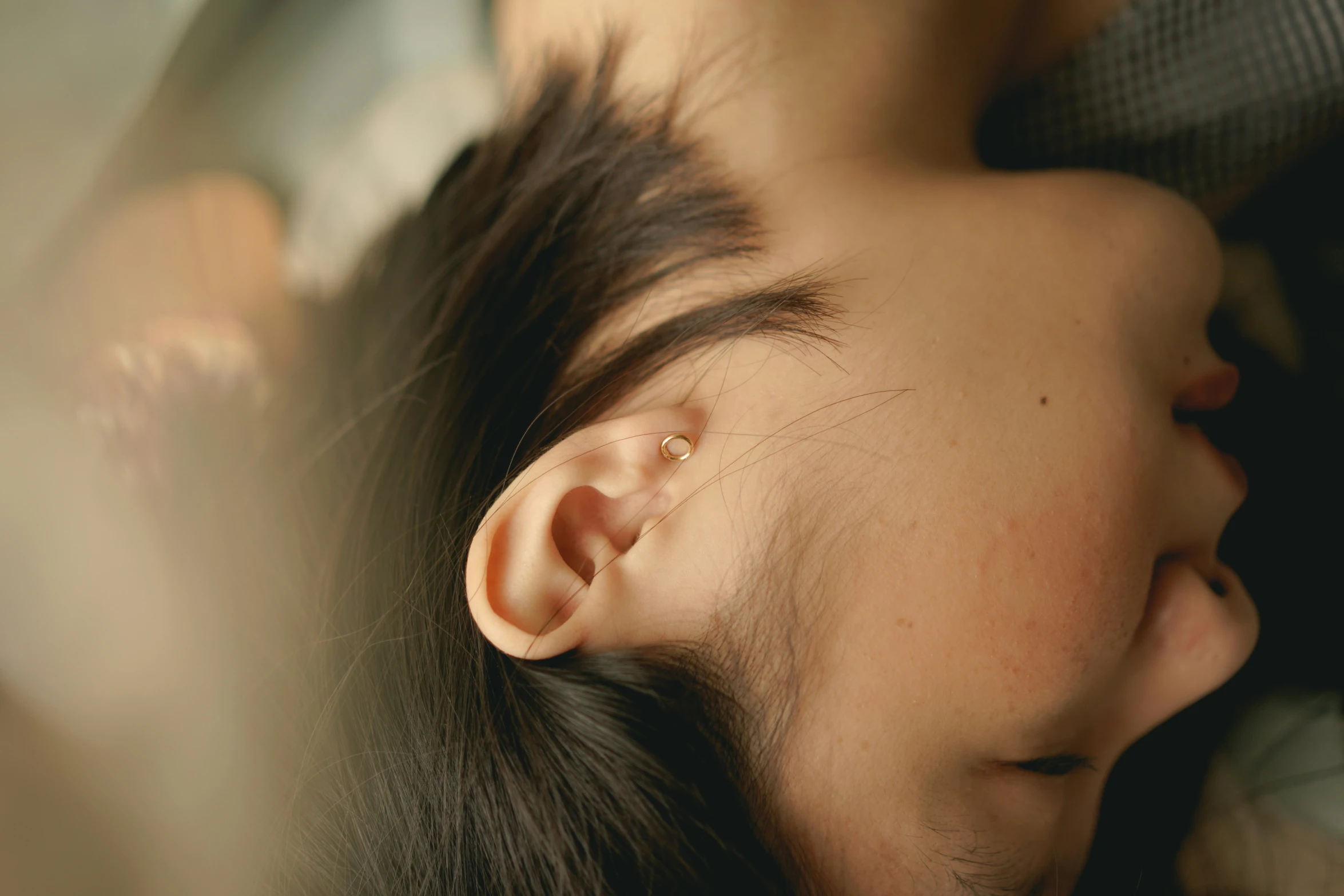 an asian woman with a hair piece resting on her ear