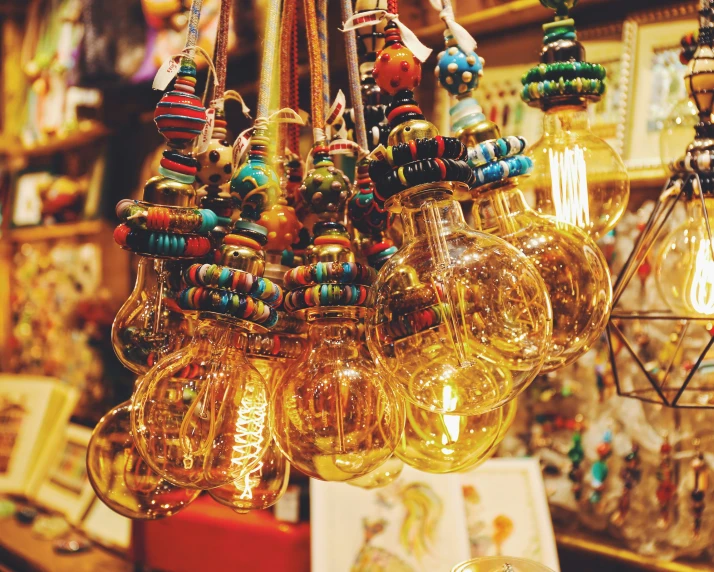 the glass ornaments of the lamps are hanging in the store