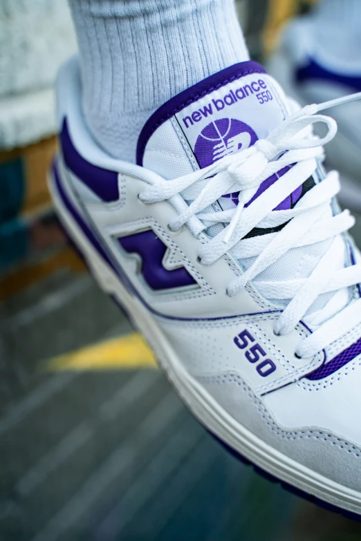 a closeup s of someone's white and purple tennis shoe