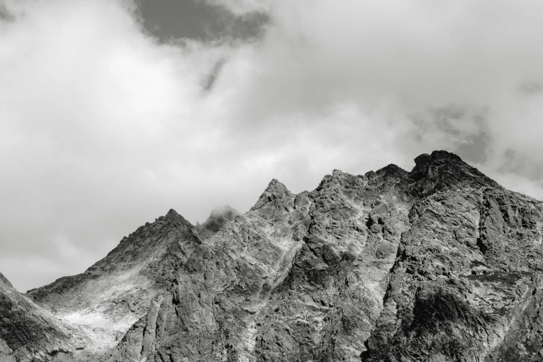 black and white image of mountain top and cloudy sky
