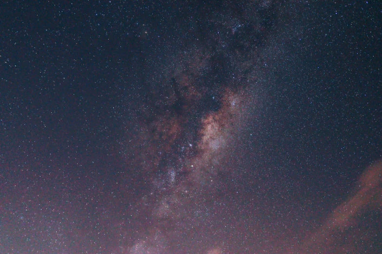 the night sky with many stars and dark clouds