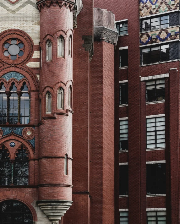 a tall red brick building with several stained glass windows