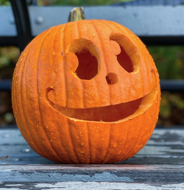 an orange pumpkin with a face carved into it