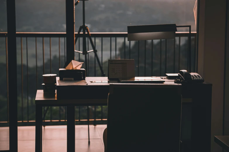 desk with lamp, desk phone and box in foreground