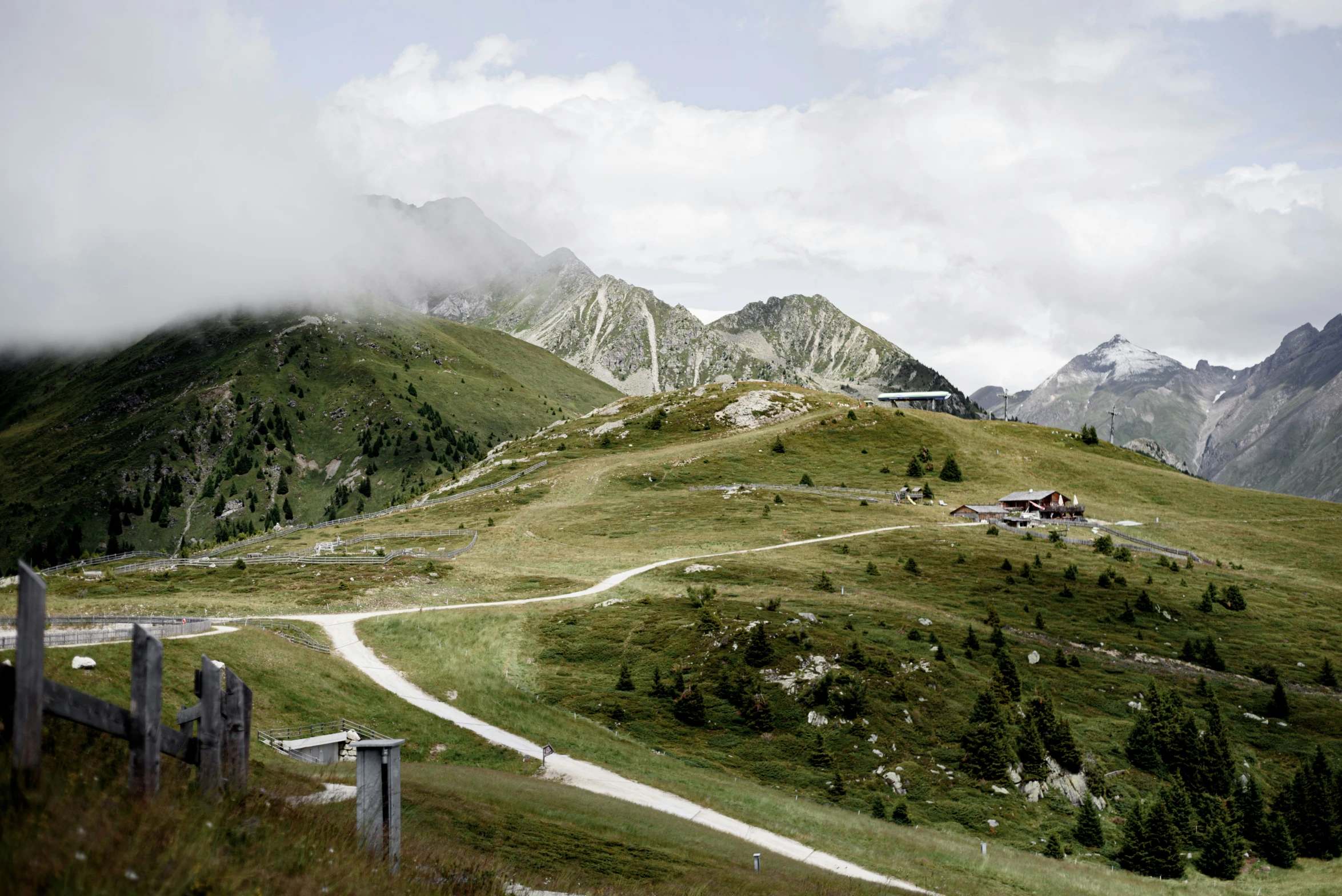 the mountains are very green with grass on the side