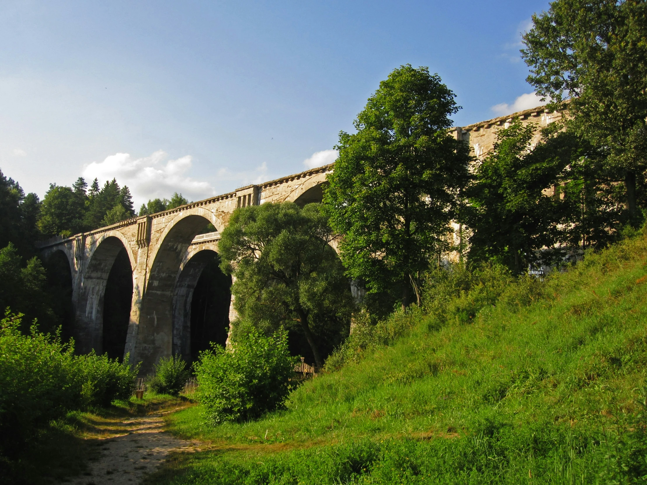 there is an old, stone bridge over the river