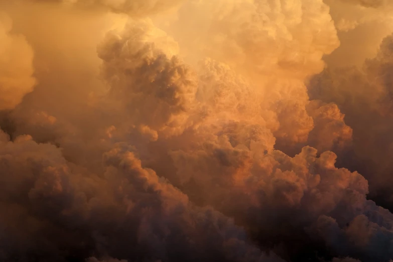 smoke comes from a fire department plane as it flies above the clouds