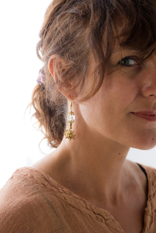 a woman with short hair wearing earrings