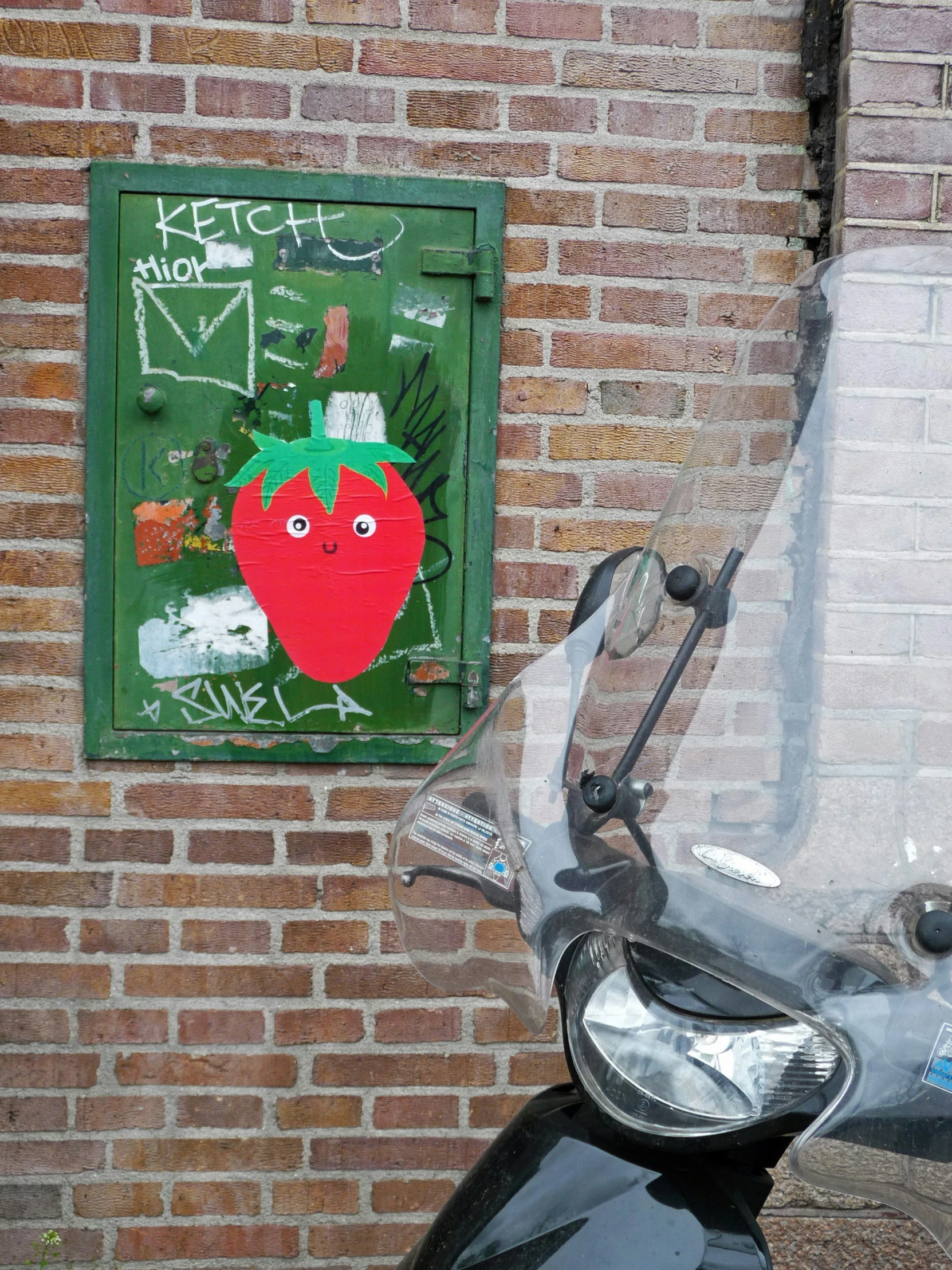 there is a painting on the wall above a motor bike