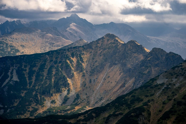 large mountains and a few clouds are seen above them