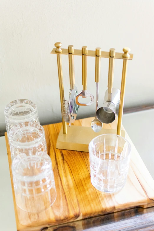 some clear glassware on a wooden  board