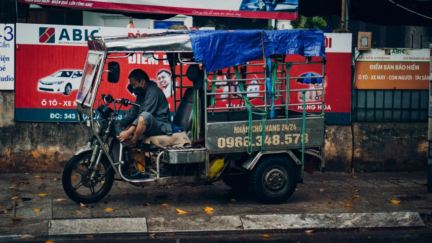 a man on a moped sits in the middle of the road