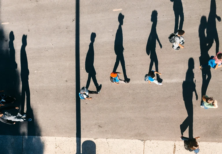 people are riding skateboards on the sidewalk