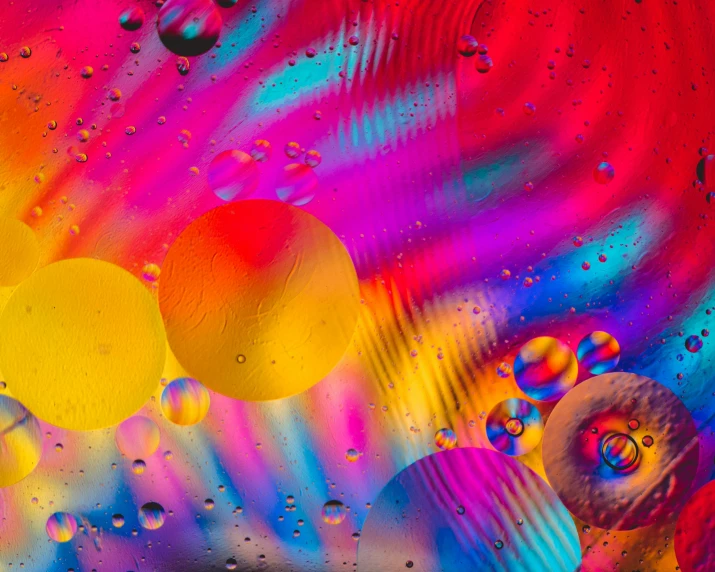 some very colorful liquid pictures that are on a counter