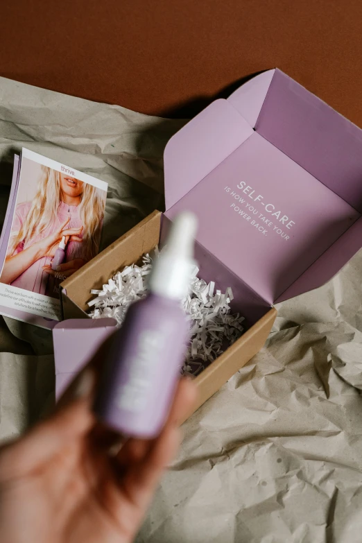 a person is open an open box of facial care products