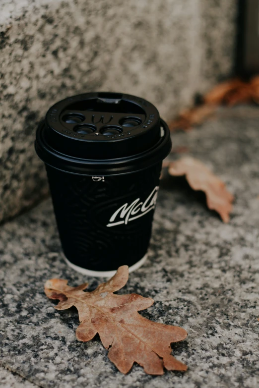 a cup that is sitting on the ground