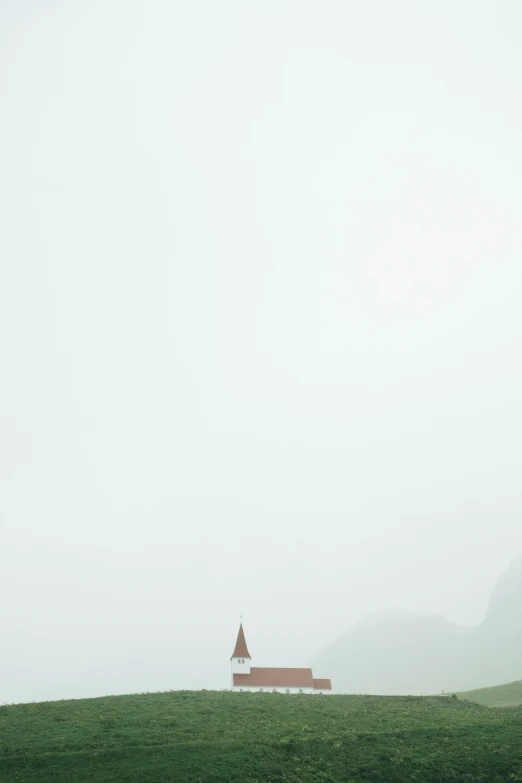 a bench stands in the distance on a misty day