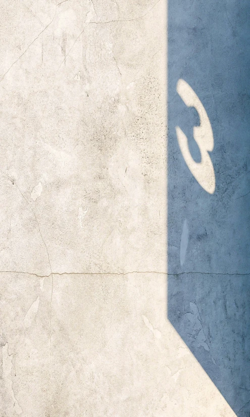 shadow of an object over a stone wall