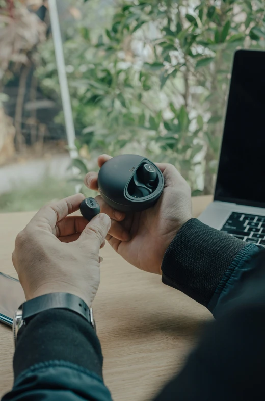 a man holding onto his computer mouse while working