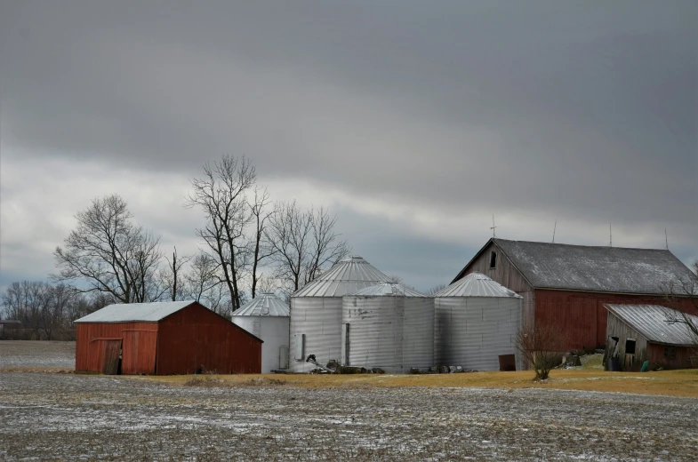 a large red barn in the middle of winter