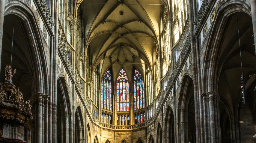 a cathedral with pews and a stone interior