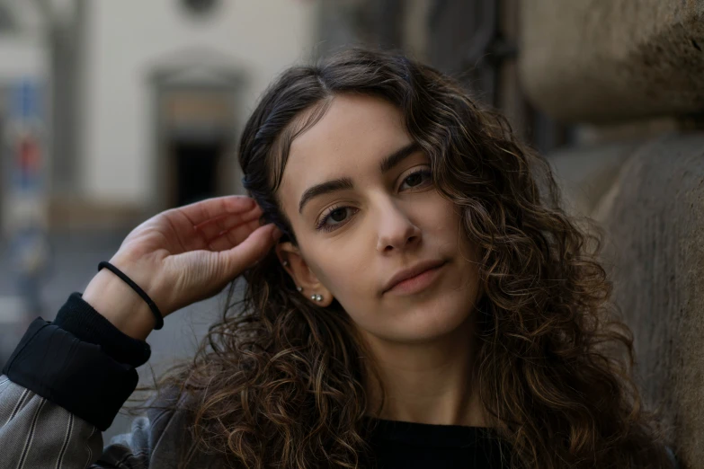 a young woman is leaning against the wall