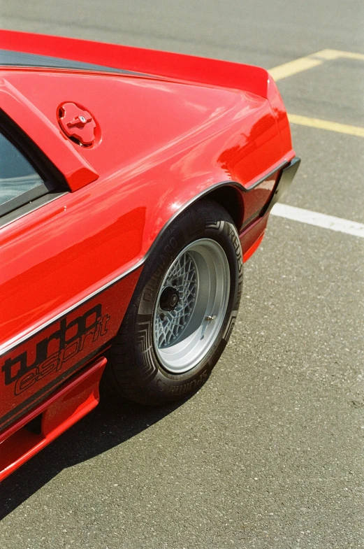 a red car with a large emblem on it's side