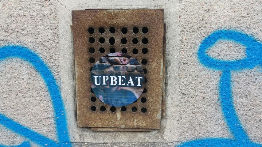 the blue stencil on the side of a building says,'treat '