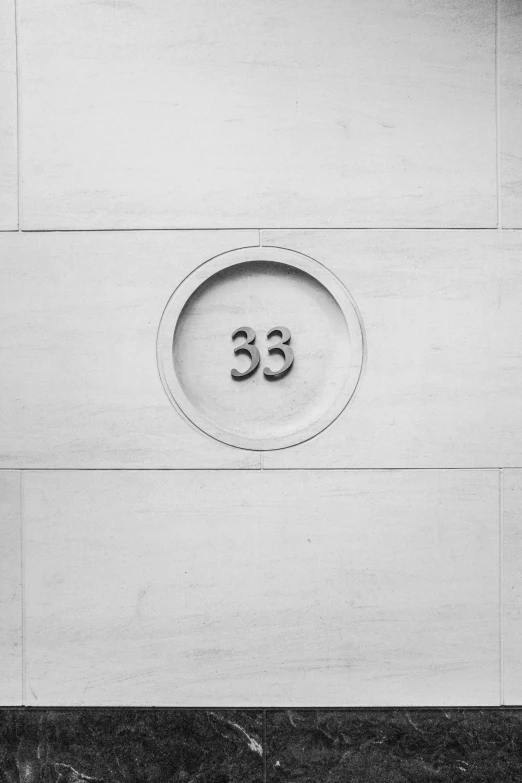 a round sign that is attached to the side of a building