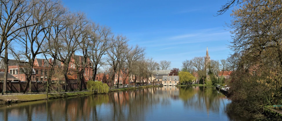 a waterway near a building complex and trees