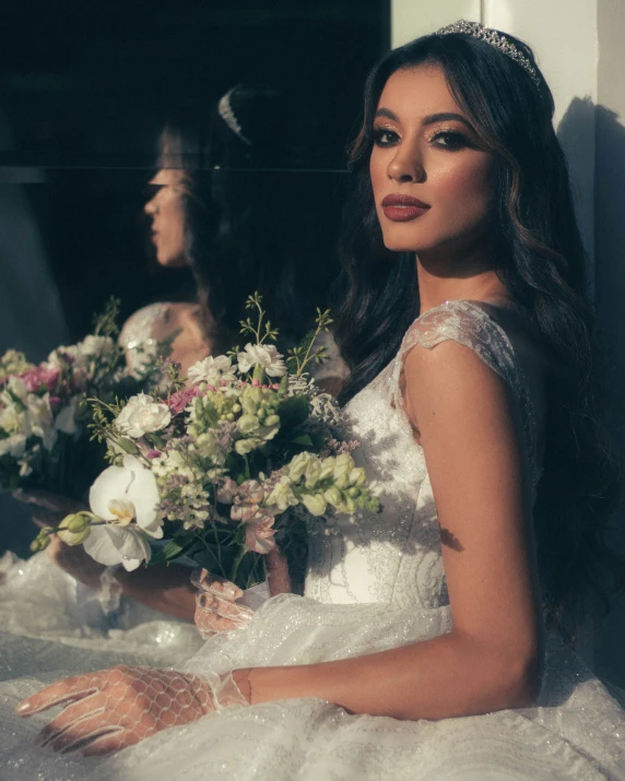 a bride poses next to a bride holding a bridal bouquet