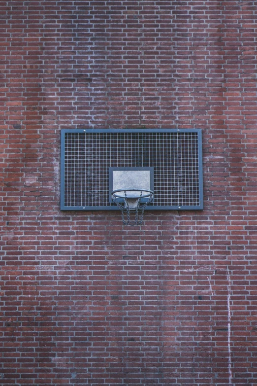 a wall has been made from bricks and a small basket is installed on the back