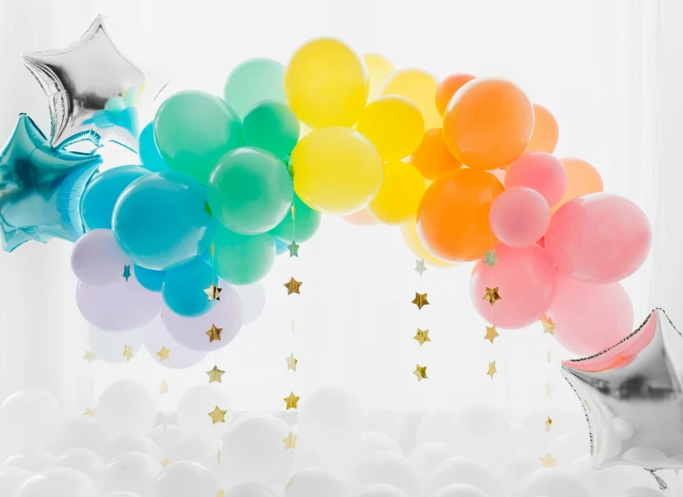 a group of balloons and star filled balloons are on a table