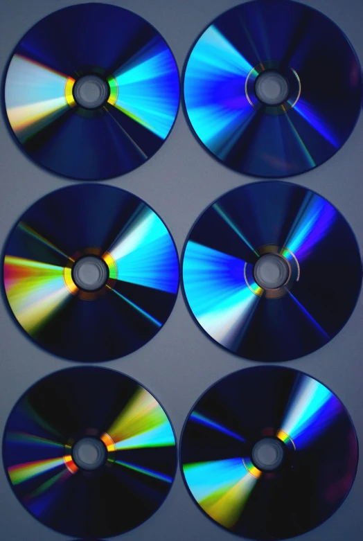four cd disks are in a row on the table
