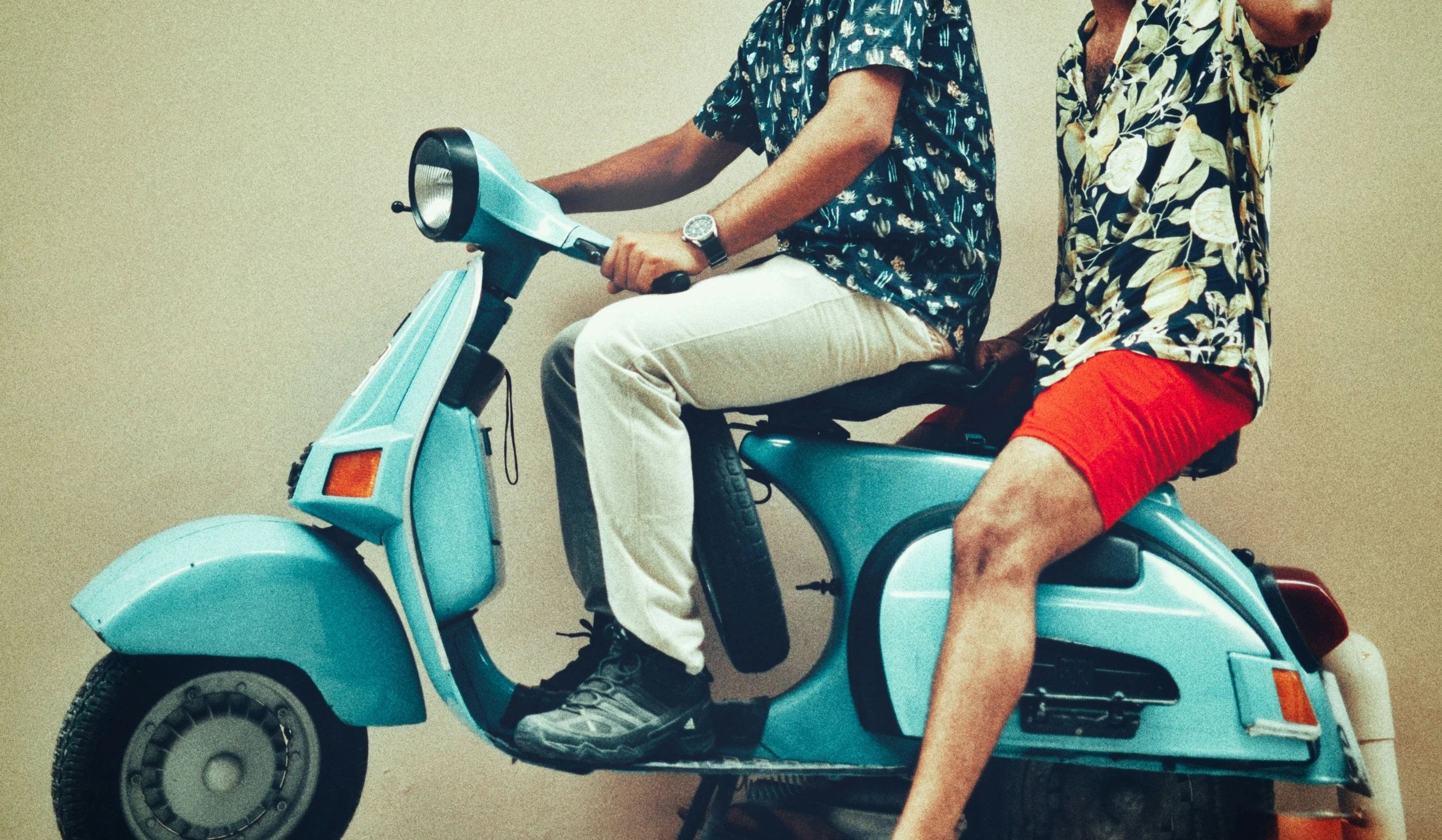 a man and a woman sitting on a moped together