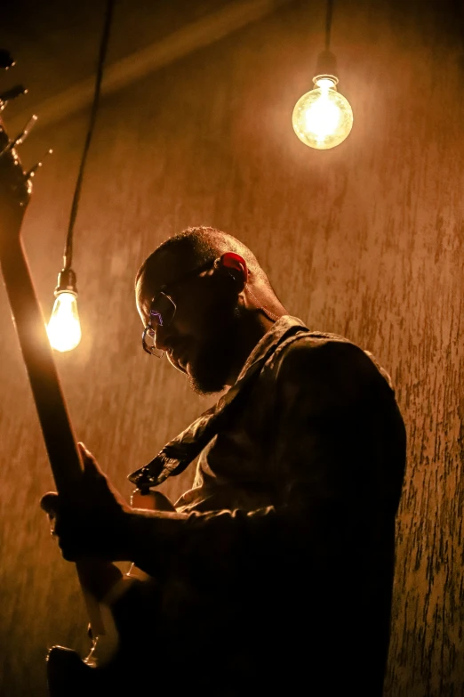 a person in front of some lighting bulbs on the floor