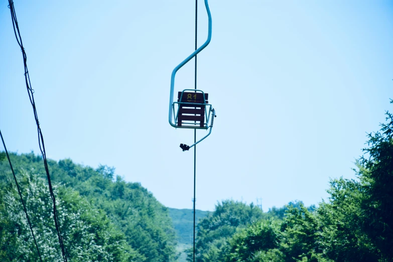 electric ski lift with trees on a sunny day